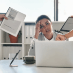 A woman in her 30s is experiencing symptoms of Burnout in a corporate setting