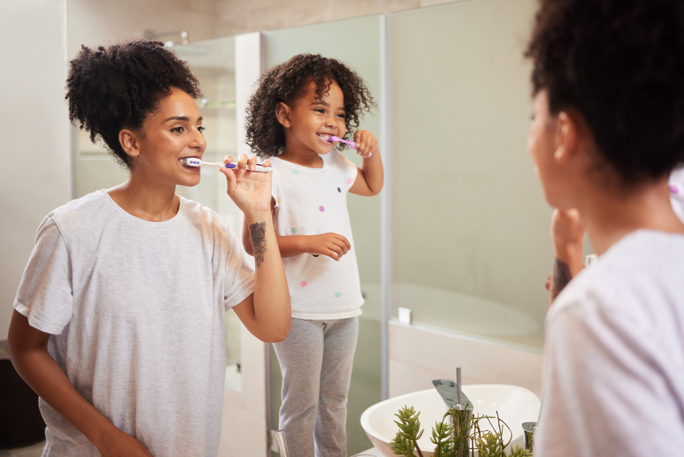 mother-and-daughter-brushing-their-teeth Mother-and-daughter-brushing-their-teeth